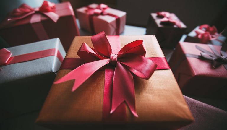 Seven neatly wrapped presents laid on a table