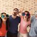 Group of adult friends wearing masks and large novelty glasses, obscuring their identities Thumbnail