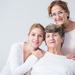 Three women - presumably related - of different age groups smiling at the camera Thumbnail