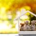 Small wooden house with bags of money inside to highlight investments Thumbnail