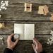 Puzzle pieces and a man holding a compass and notepad on a desk to signify different strategies Thumbnail