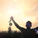 Silhouette of model holding up a No.1 medal with fists clenched in celebration Thumbnail